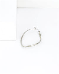 Silver hoop earring on a white background