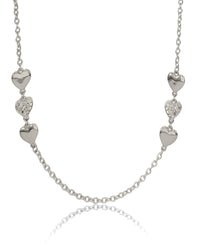 Silver necklace with heart-shaped pendants on a white background