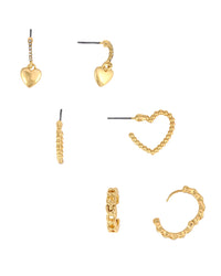 A set of three gold-toned earrings displayed on a solid white background, including three heart-shaped designs, a twisted chain drop, a beaded heart outline, a twisted chain hoop, a textured band hoop, and a twisted chain C-hoop.