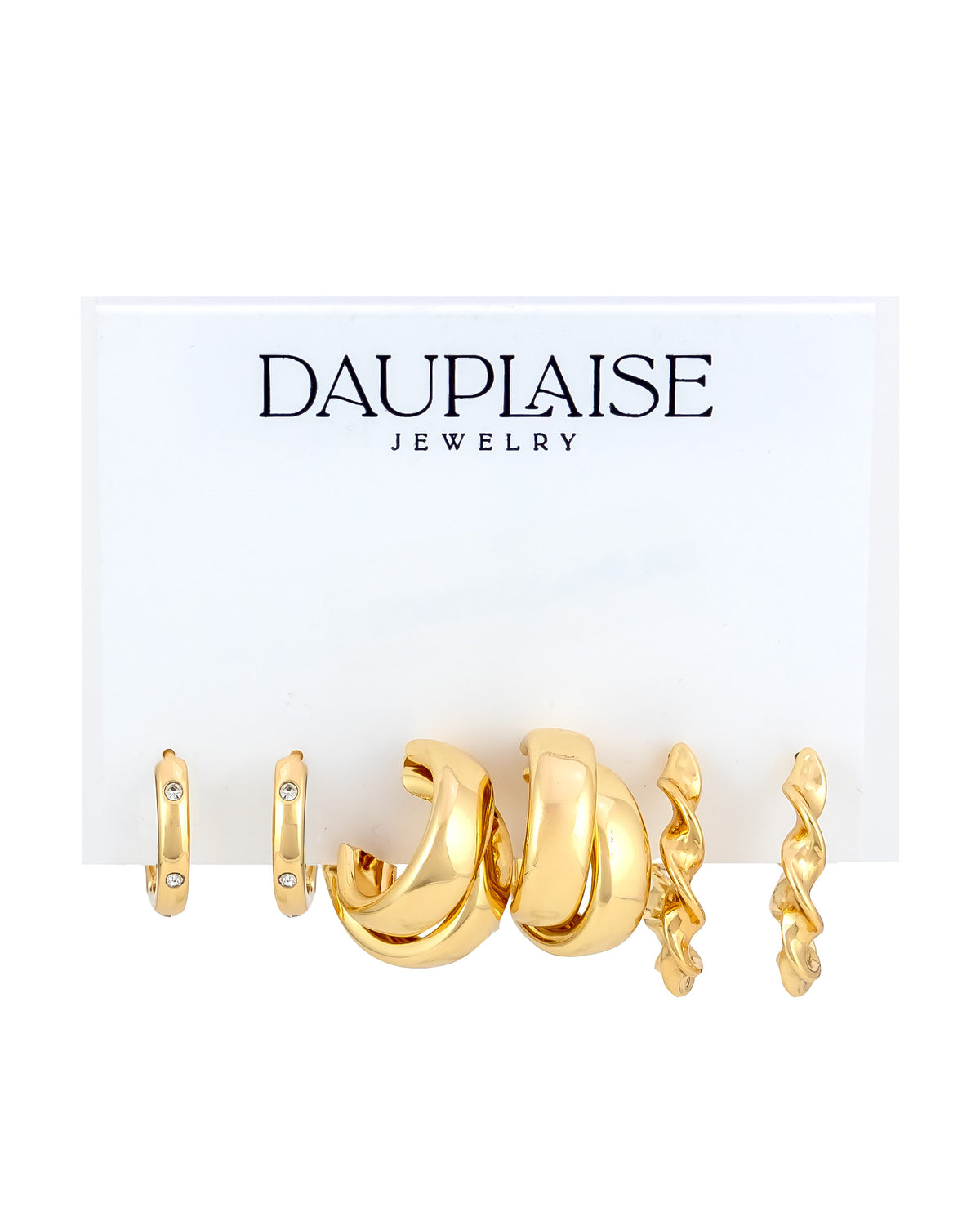 A set of three gold-toned huggie hoop earrings from Dauplaise Jewelry, displayed on a white branded card against a white background.