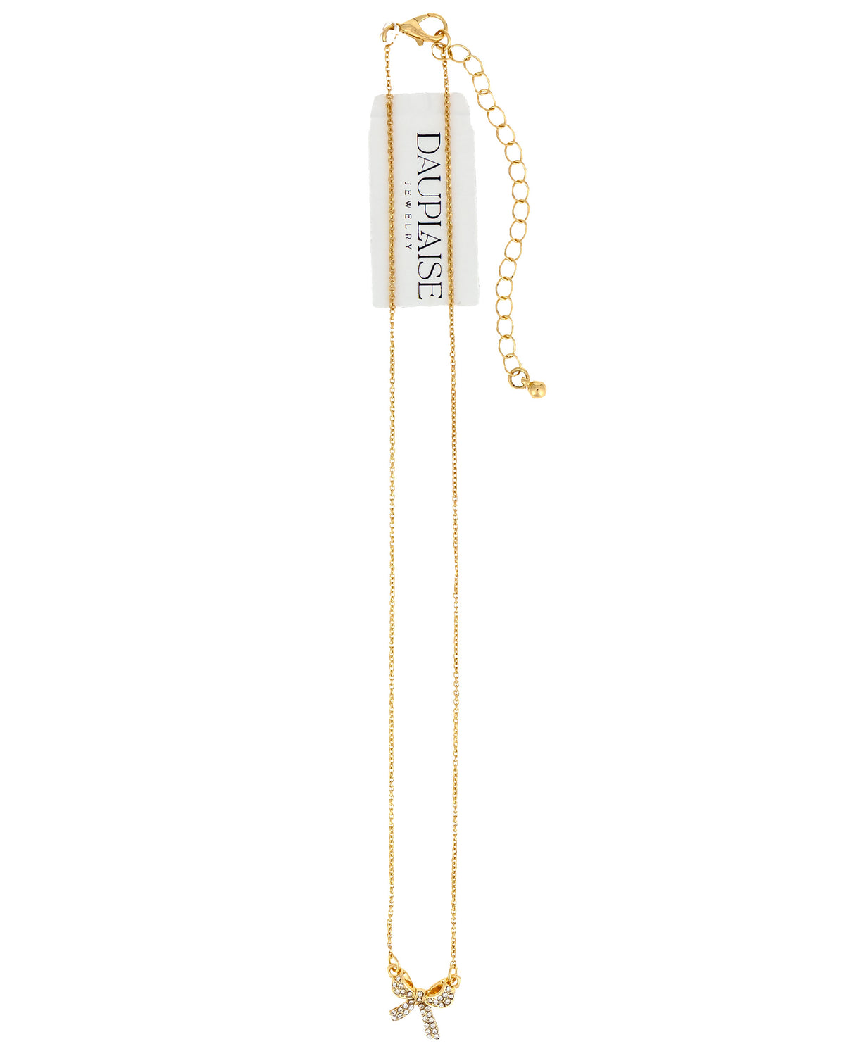 A delicate gold chain necklace with a bow charm embellished with small clear rhinestones, hanging from a white paper tag that reads 'DAUPHISE'.