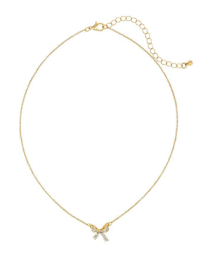 A delicate gold chain necklace with a small bow charm adorned with clear rhinestones, displayed on a clean white background.