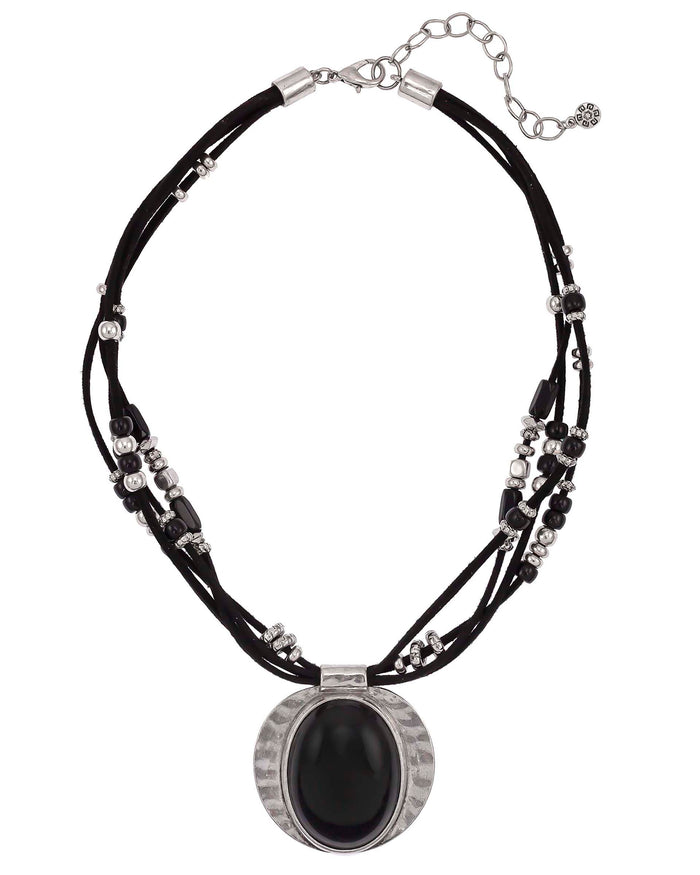 Black multi-strand cord necklace with beads and an oval black cabochon in an antique-silver-tone frame on a white background.