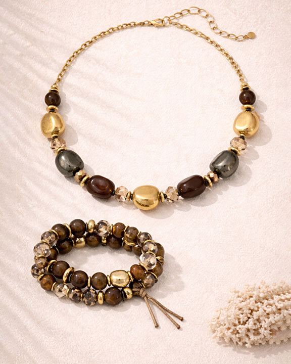 Necklace and bracelet set with beads on a textured surface