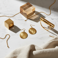 Gold Disc Drop Earrings lifestyle shot – high contrast flat lay
