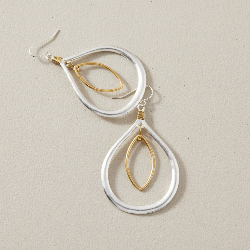 Two-Tone Orbital Teardrop Earrings lifestyle shot – artistic arrangement