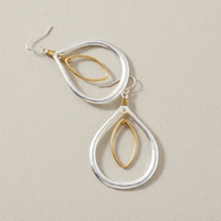 Two-Tone Orbital Teardrop Earrings lifestyle shot – artistic arrangement